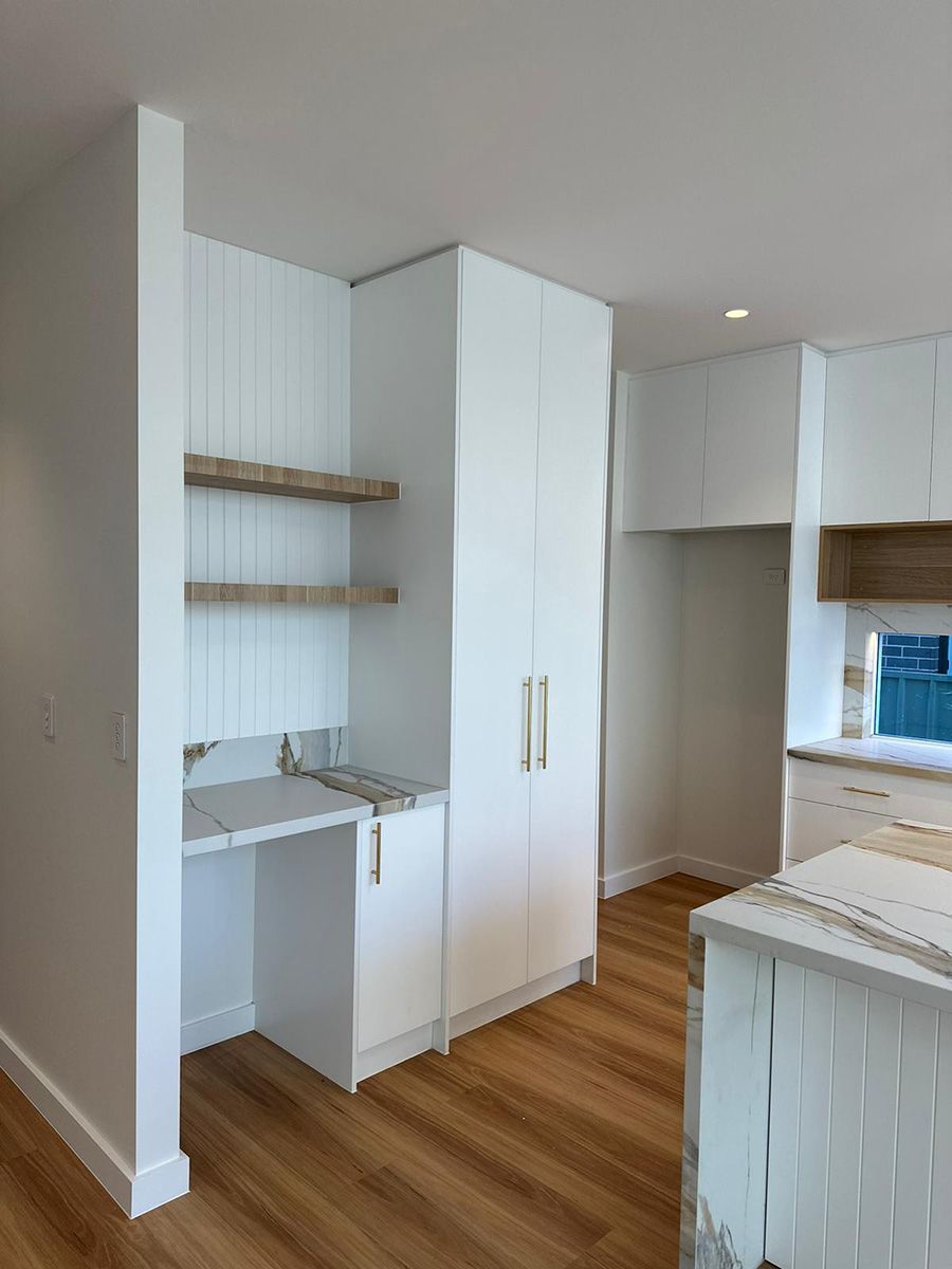 Modern Kitchen With Open Shelving and Tall Storage — JMB Electrical Services In Port Kembla, NSW