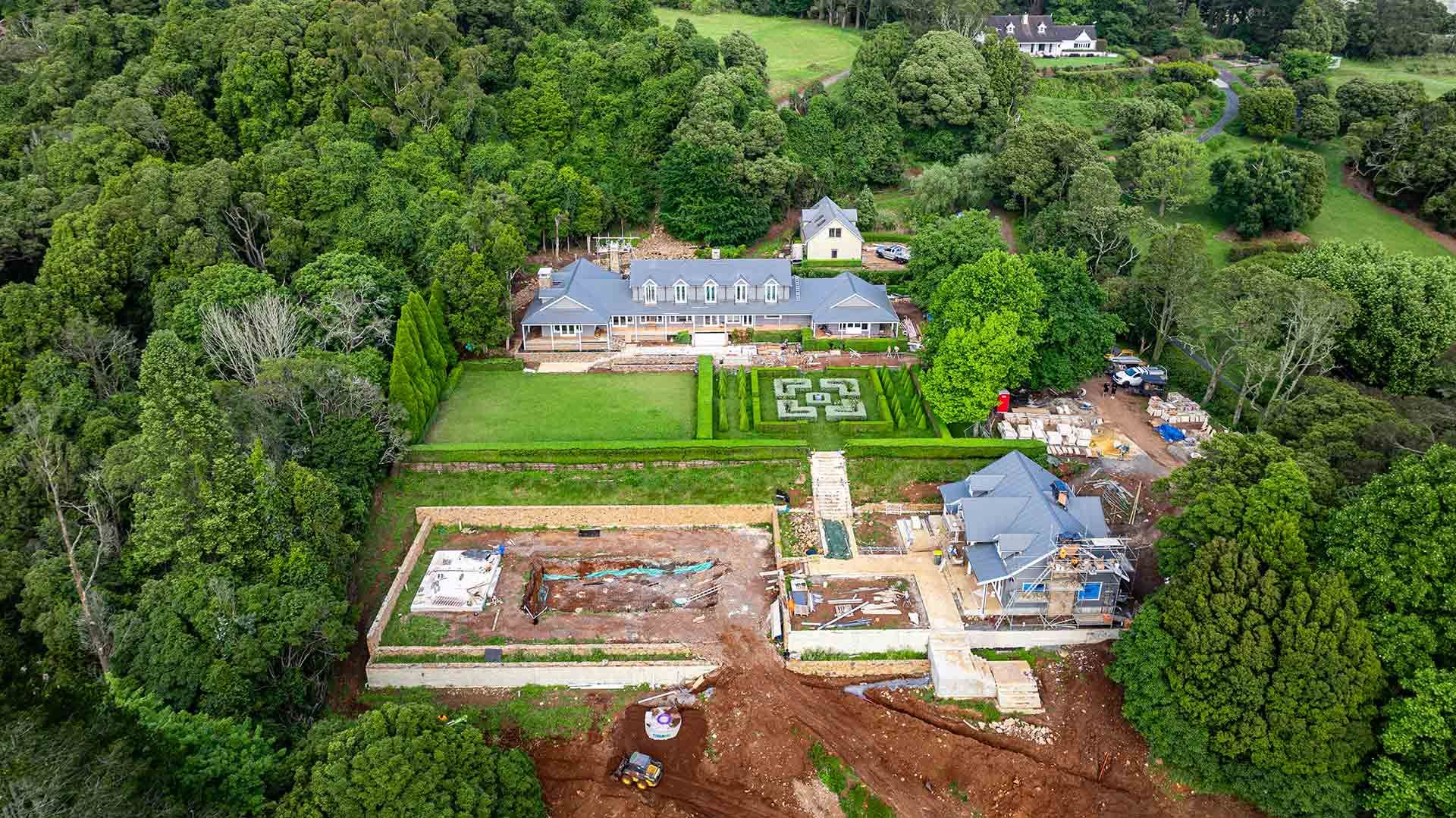 Large Estate With a Blue-roofed House, Surrounded by Trees — JMB Electrical Services In Port Kembla, NSW