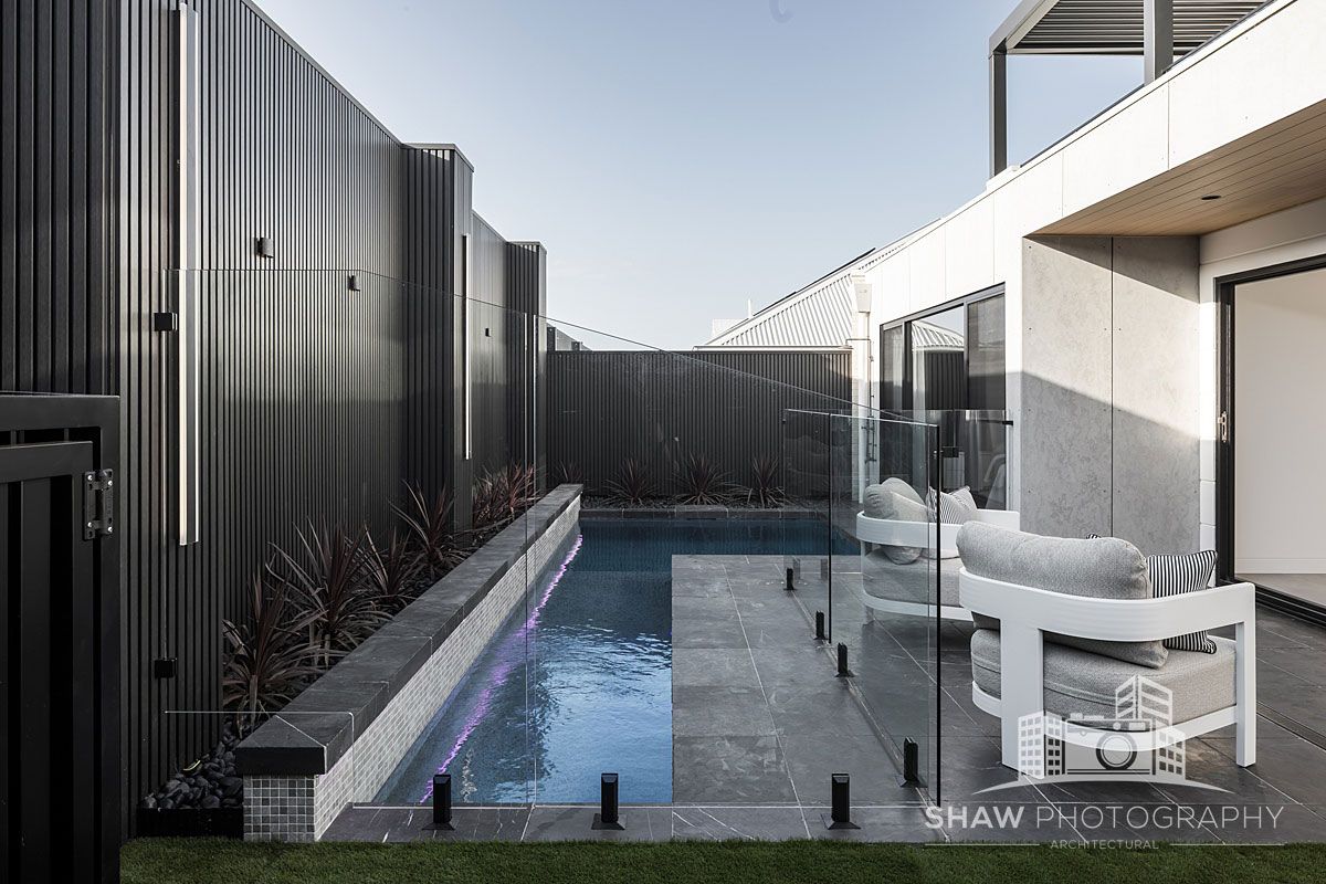 Modern Outdoor Pool Area With Glass Fence — JMB Electrical Services In Port Kembla, NSW