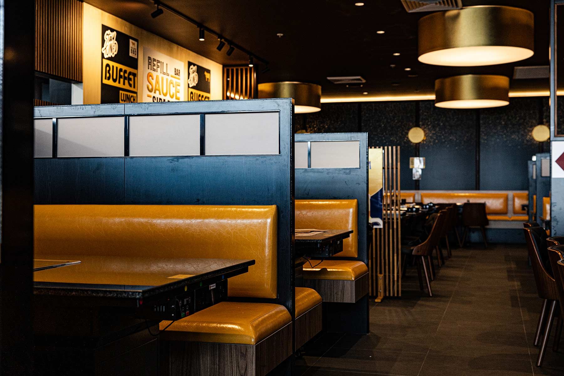 Modern Restaurant Interior With Warm Lighting and Signage — JMB Electrical Services In Port Kembla, NSW