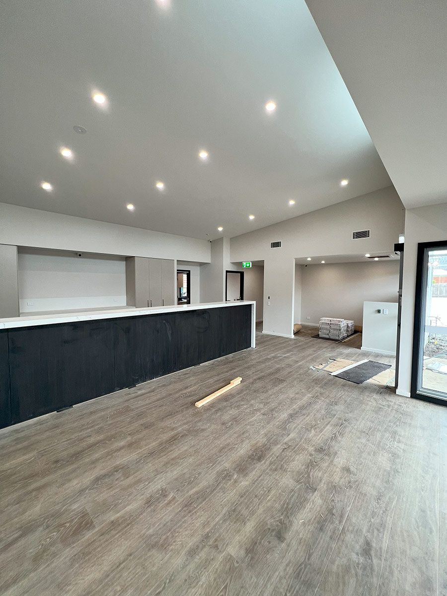 Spacious Room With Large Island and Wood Flooring — JMB Electrical Services In Port Kembla, NSW