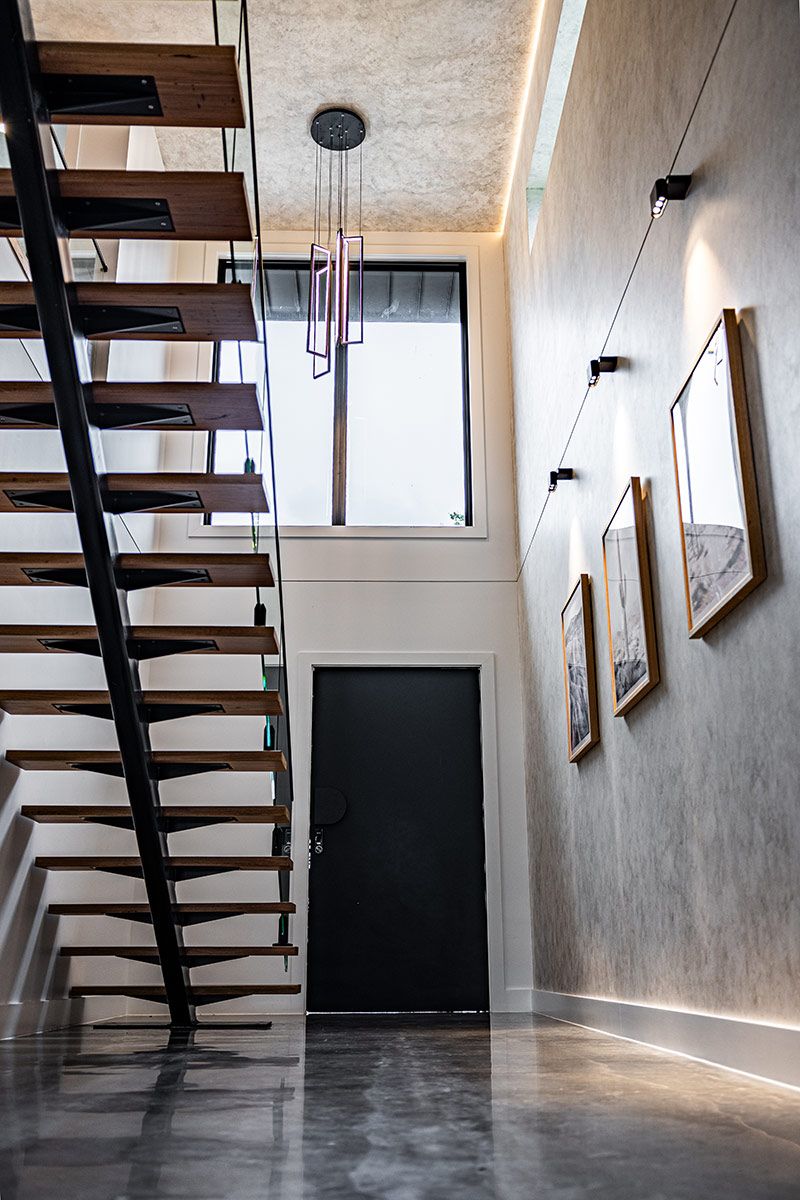 Modern Interior With Wooden Staircase and a Large Window — JMB Electrical Services In Port Kembla, NSW