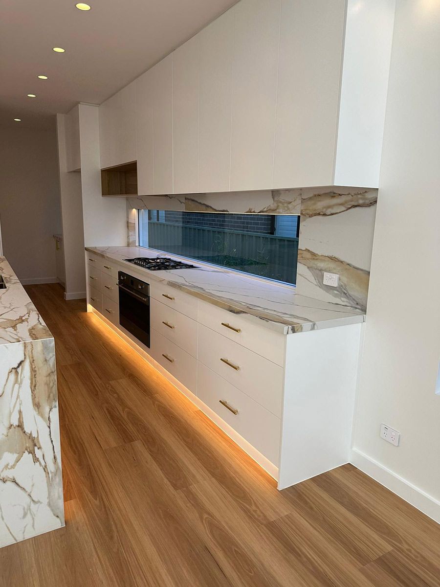 Sleek Kitchen Featuring White Cabinets — JMB Electrical Services In Port Kembla, NSW