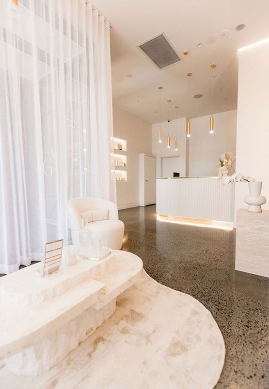 Reception Area With Curtains, Plush Chair, and a Marble Table — JMB Electrical Services In Port Kembla, NSW