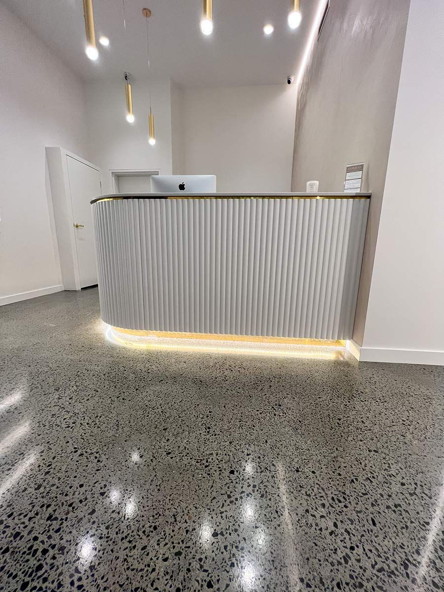 A Reception Area With a Glossy Speckled Floor — JMB Electrical Services In Port Kembla, NSW