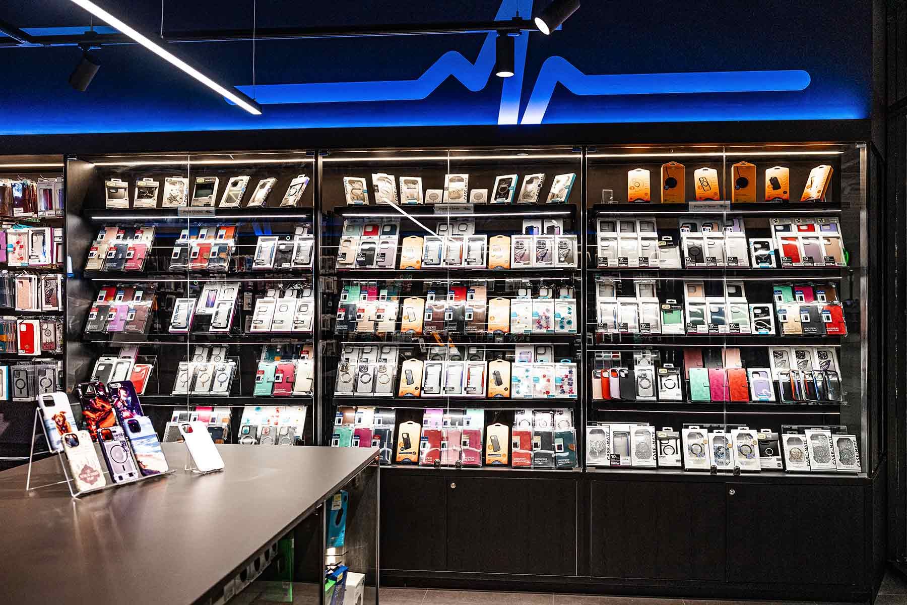 Wall Display With Neatly Arranged Phone Cases — JMB Electrical Services In Port Kembla, NSW