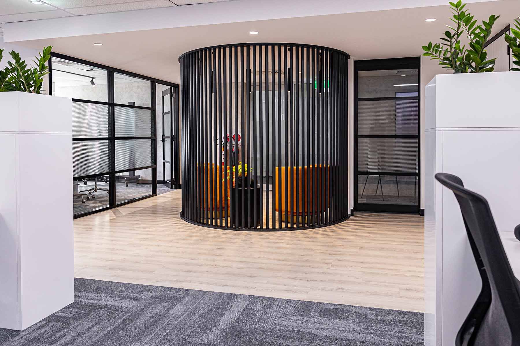 Office Interior With a Rounded Black Vertical Slat Partition — JMB Electrical Services In Port Kembla, NSW