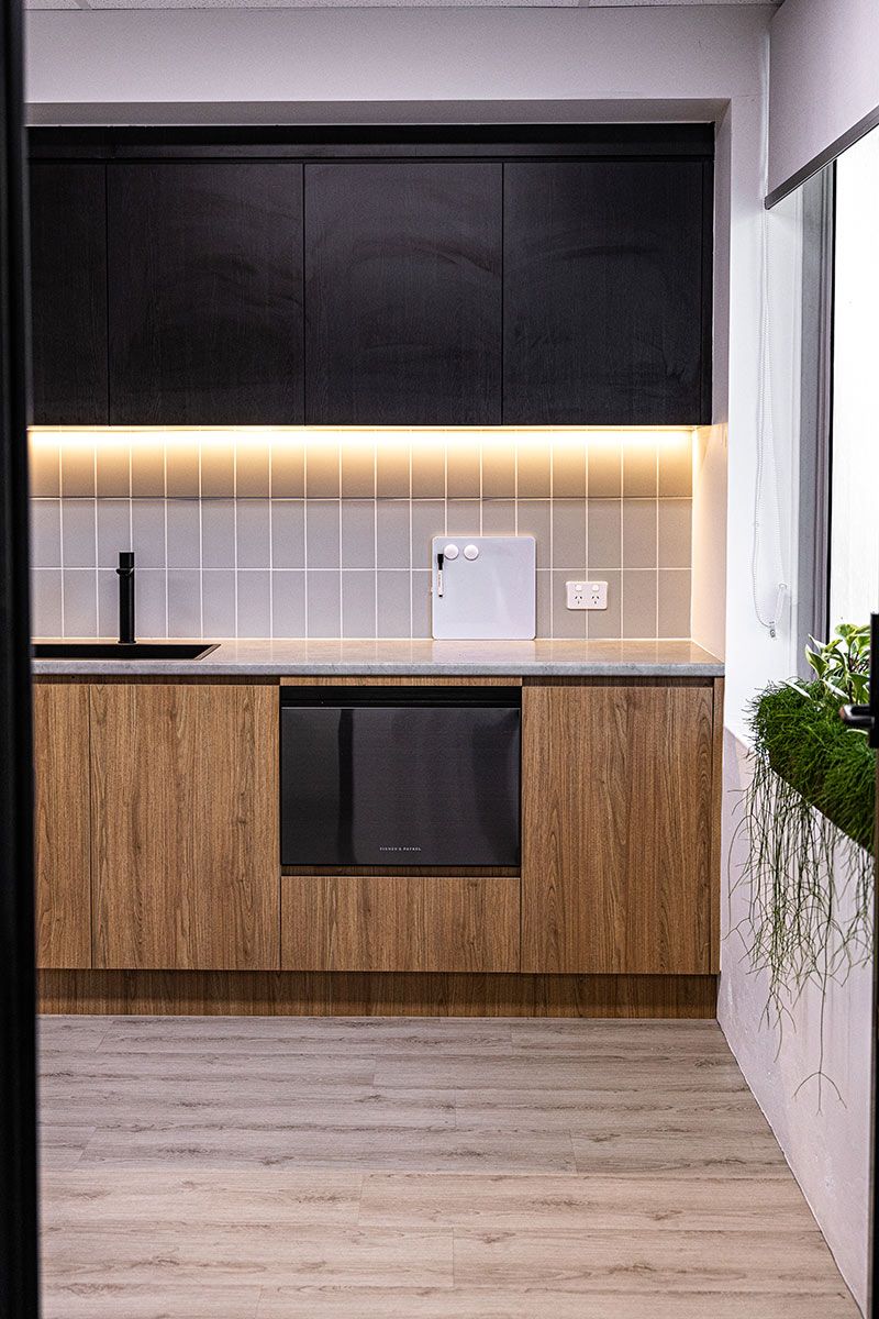 A Kitchen With Wooden Cabinets — JMB Electrical Services In Port Kembla, NSW
