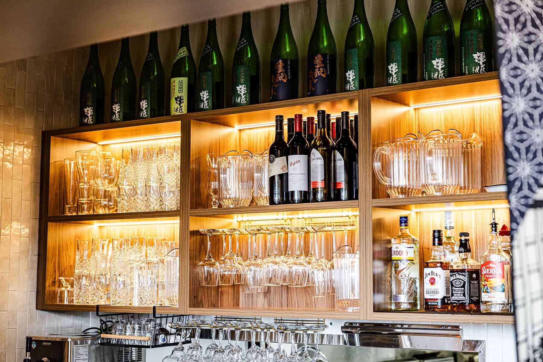 Wooden Bar Shelves With Glassware, Wine Bottles, and Assorted Spirits — JMB Electrical Services In Port Kembla, NSW