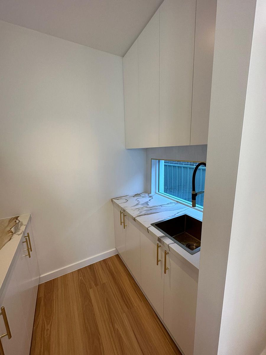 Room With Wood Flooring and White Cabinets — JMB Electrical Services In Port Kembla, NSW