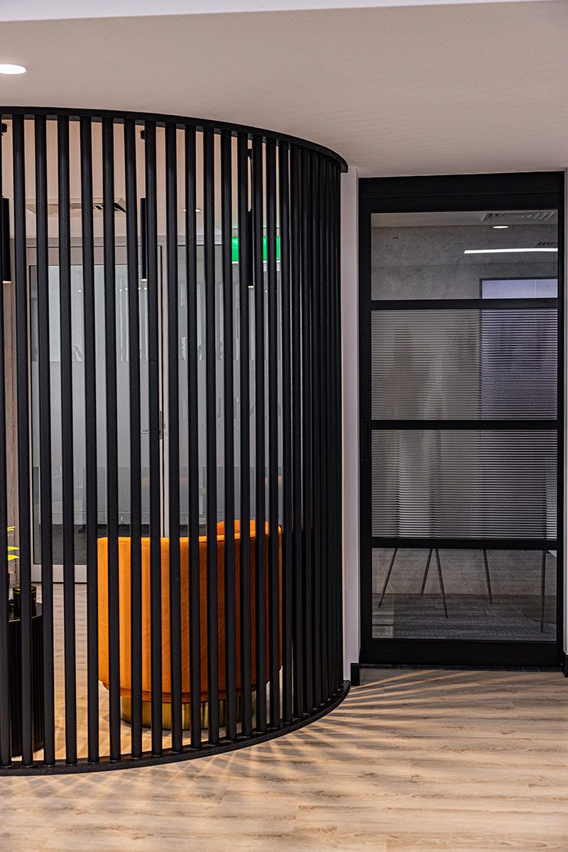 A Room With a Black Fence and a Glass Door — JMB Electrical Services In Port Kembla, NSW