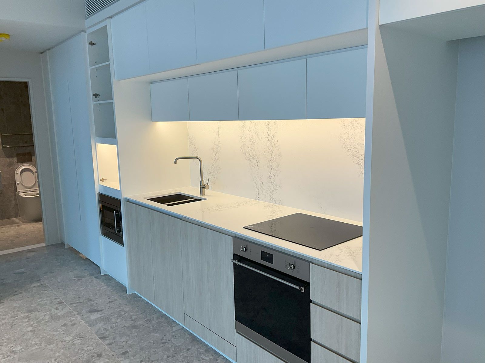 Modern Kitchen With a Stainless Steel Oven and a Faucet — JMB Electrical Services In Port Kembla, NSW