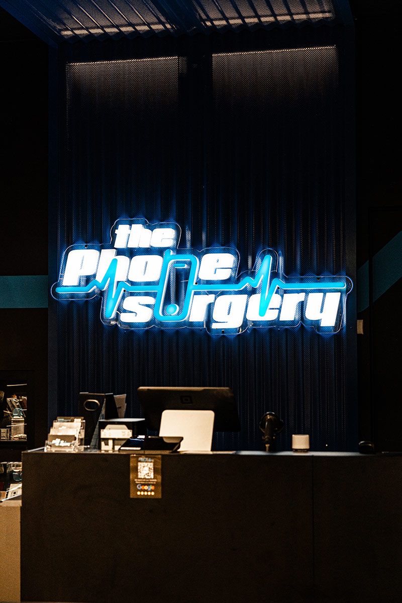 Front Desk of a Tech Repair Shop Featuring a Blue Sign — JMB Electrical Services In Port Kembla, NSW