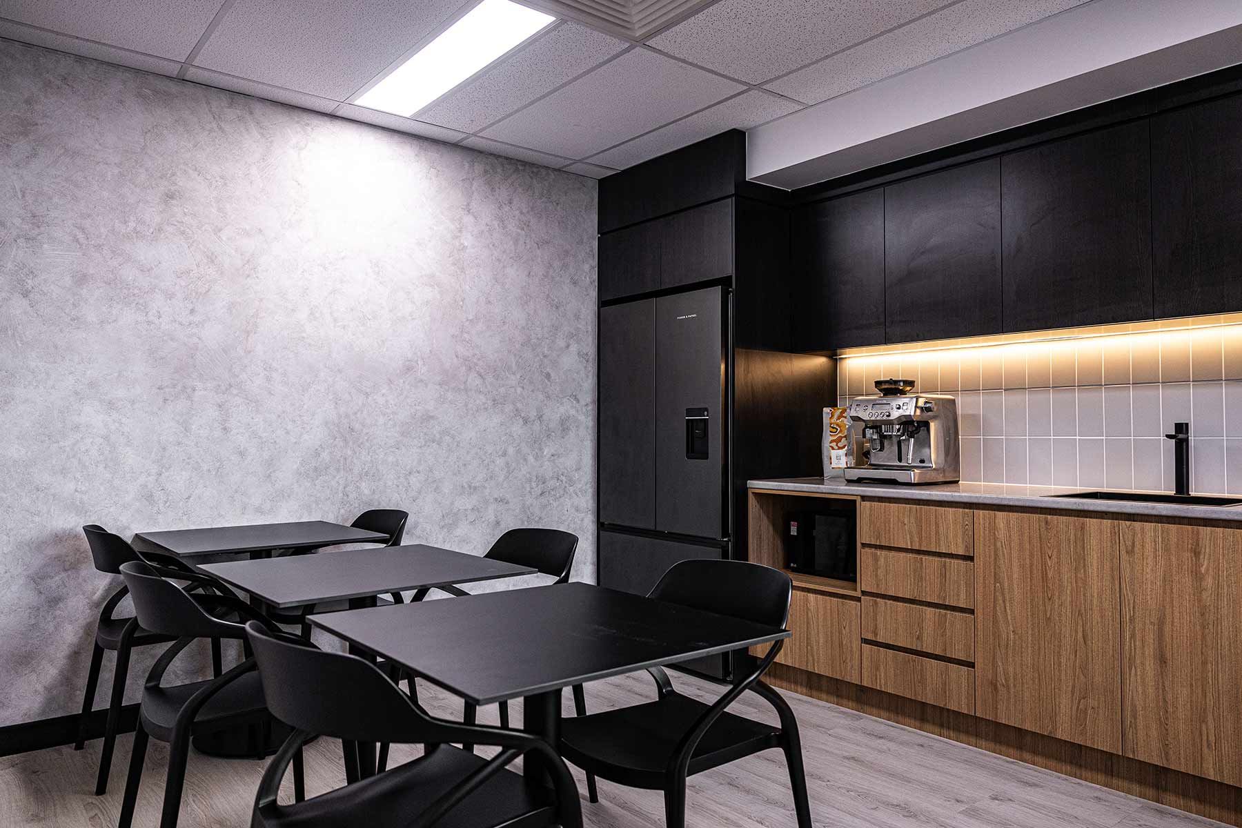 A Kitchen With Black Tables and Chairs — JMB Electrical Services In Port Kembla, NSW