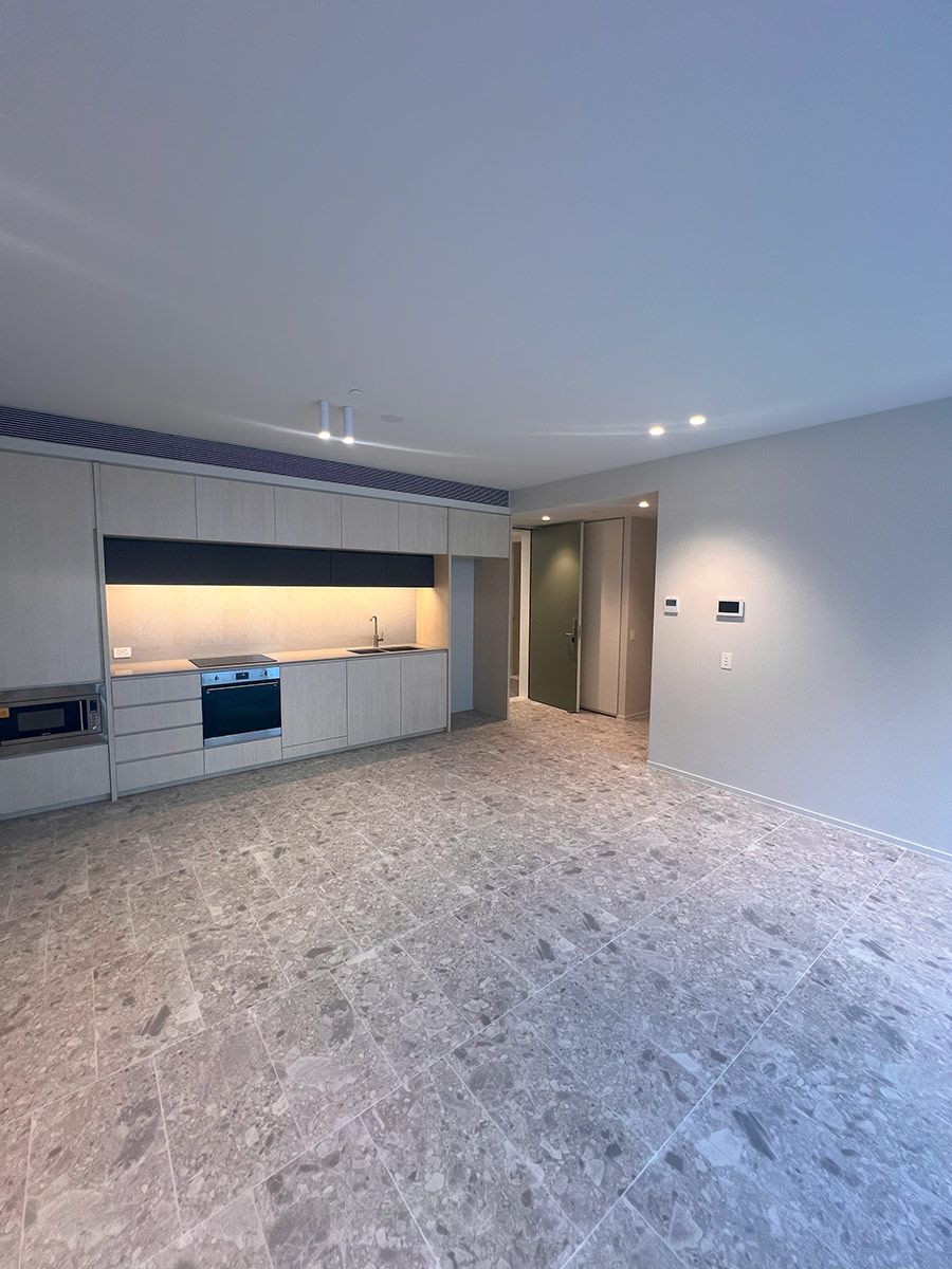 Modern Kitchen With Light Wood Cabinetry and an Integrated Oven — JMB Electrical Services In Port Kembla, NSW