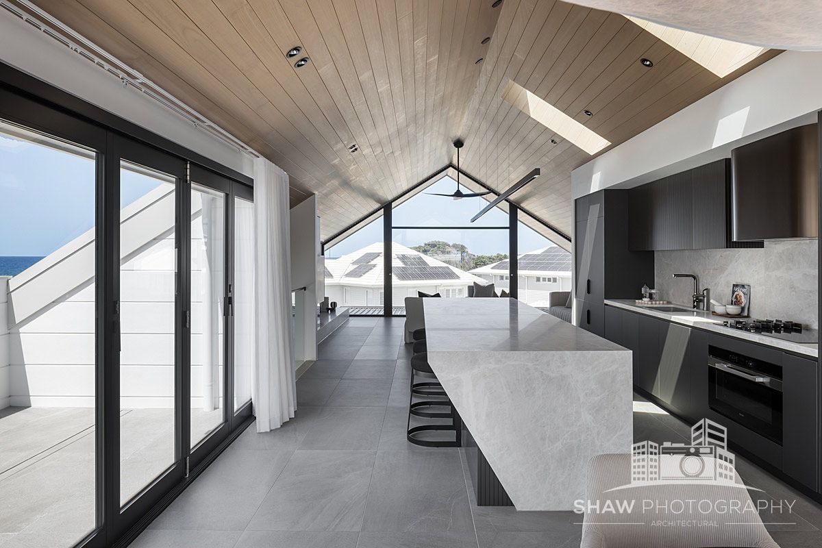 A Kitchen With a Large Island and Lots of Windows — JMB Electrical Services In Port Kembla, NSW