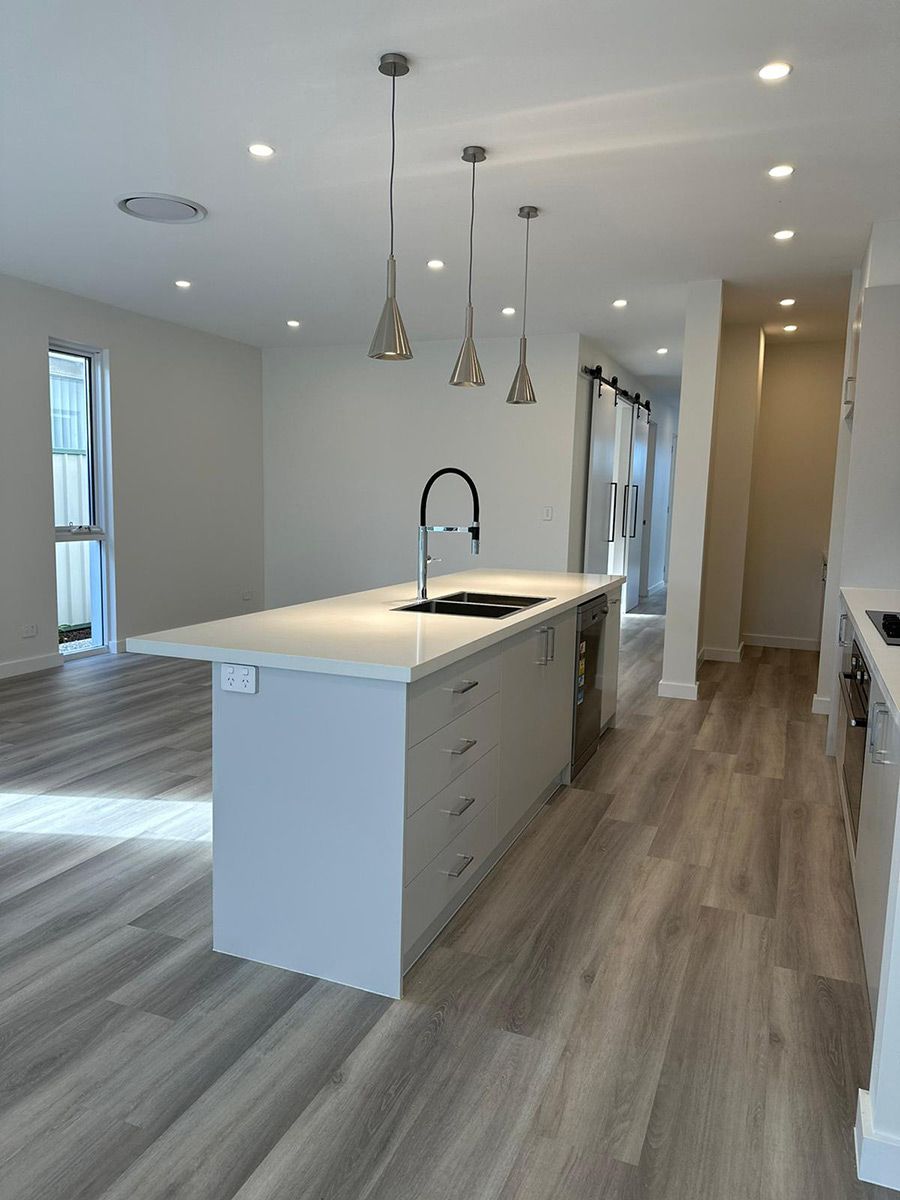 Kitchen With Pendant Lights and Light Wood Flooring — JMB Electrical Services In Port Kembla, NSW