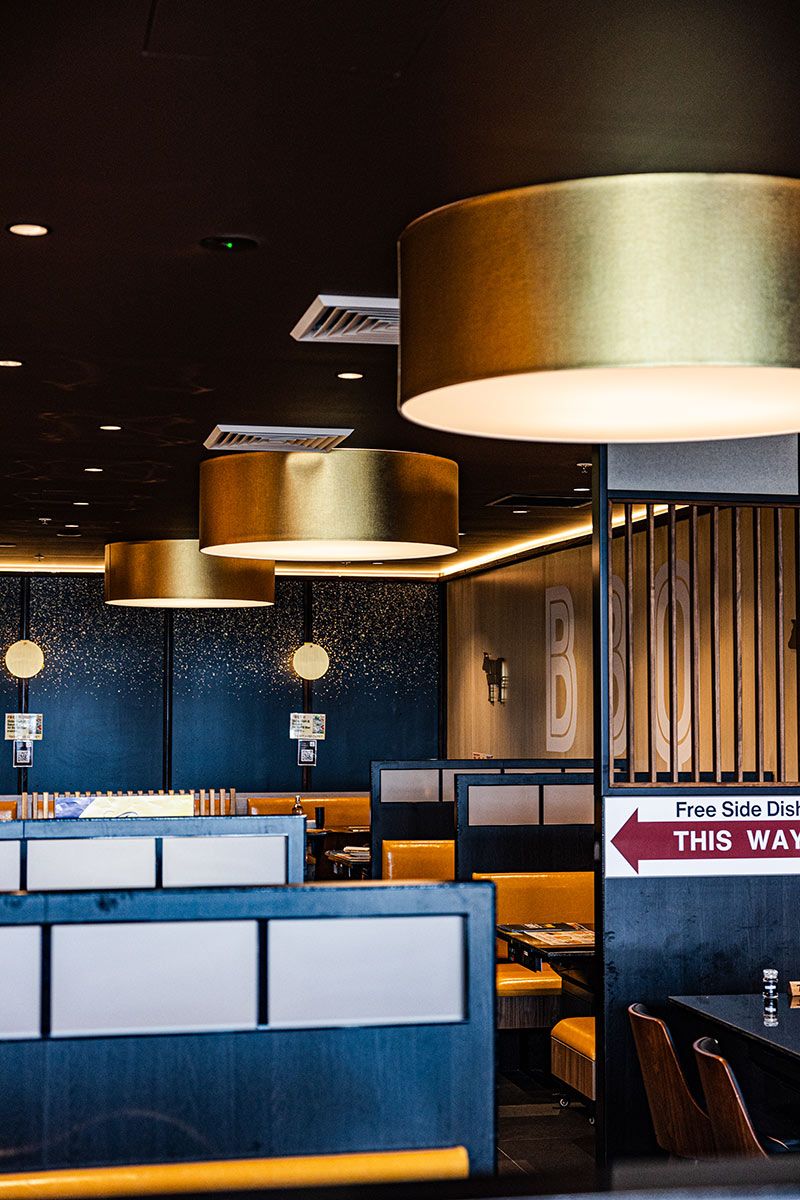 Modern Restaurant Interior With Gold Cylindrical Lights — JMB Electrical Services In Port Kembla, NSW