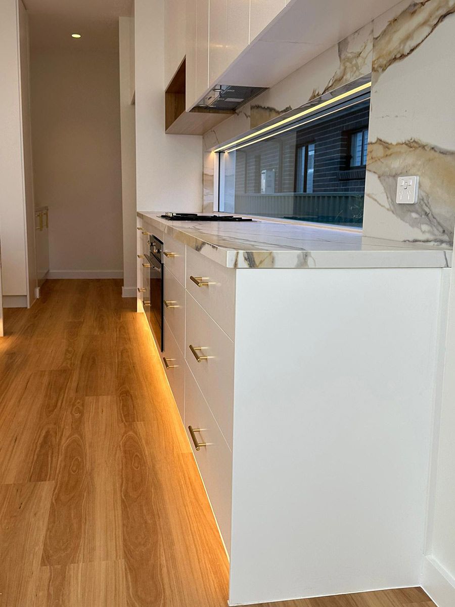 White Cabinets With Gold Handles — JMB Electrical Services In Port Kembla, NSW