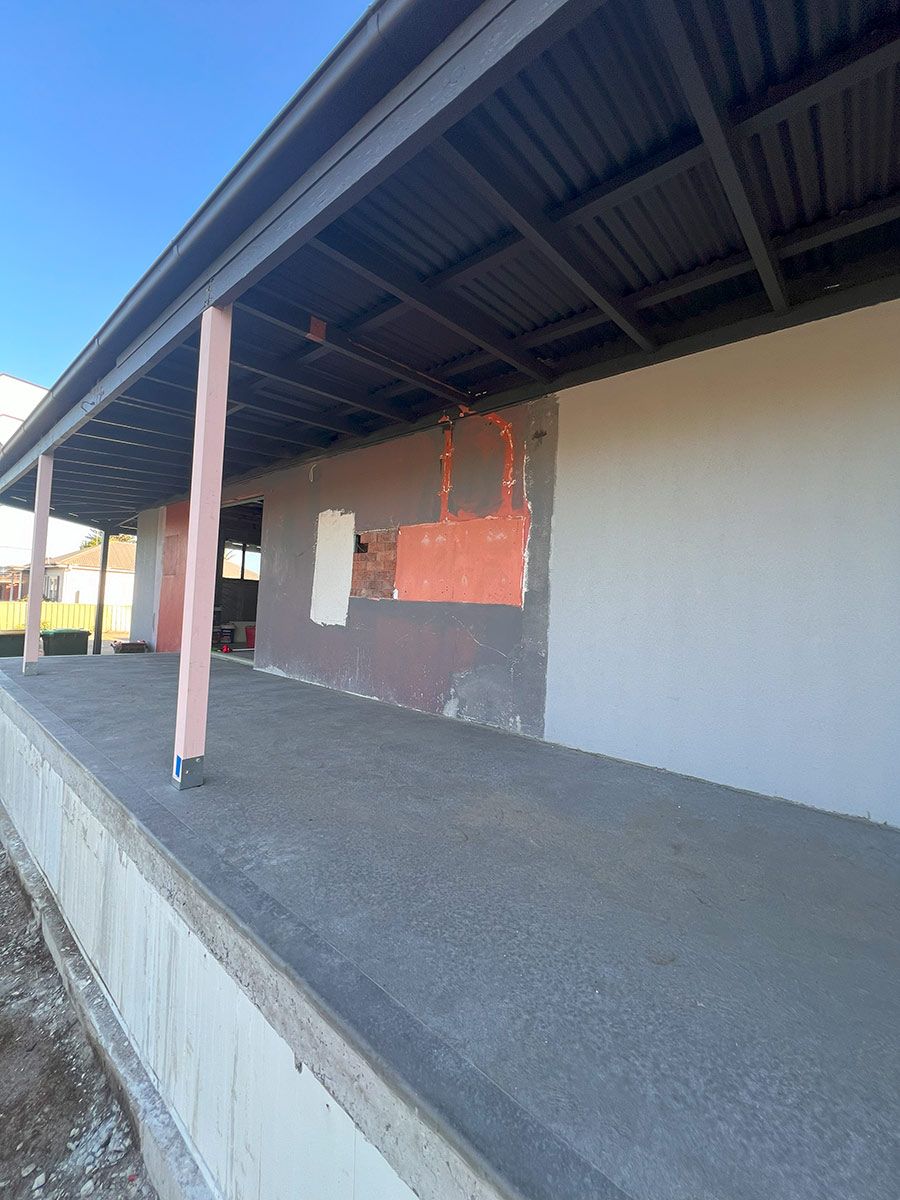 Elevated Concrete Patio Under a Black Metal Roof — JMB Electrical Services In Port Kembla, NSW