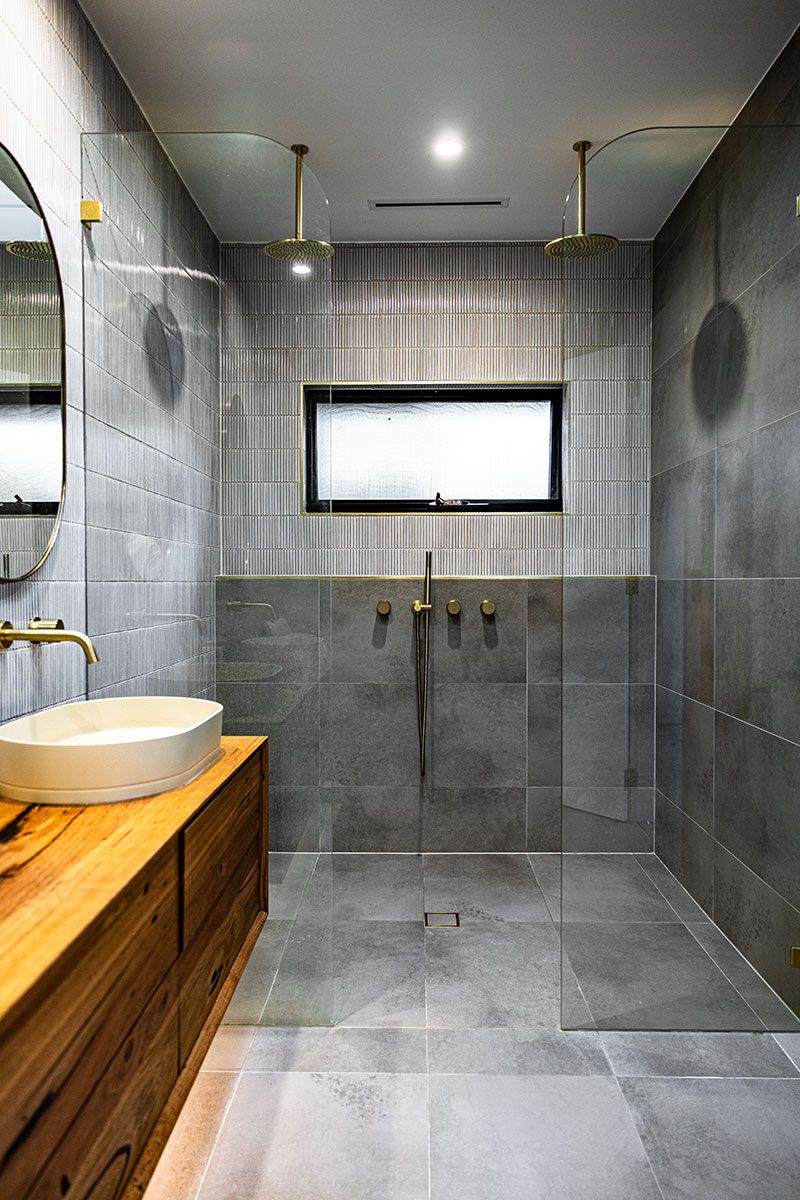 Bathroom With a Wooden Vanity, Round Basin, and Glass Walk-in Shower — JMB Electrical Services In Port Kembla, NSW