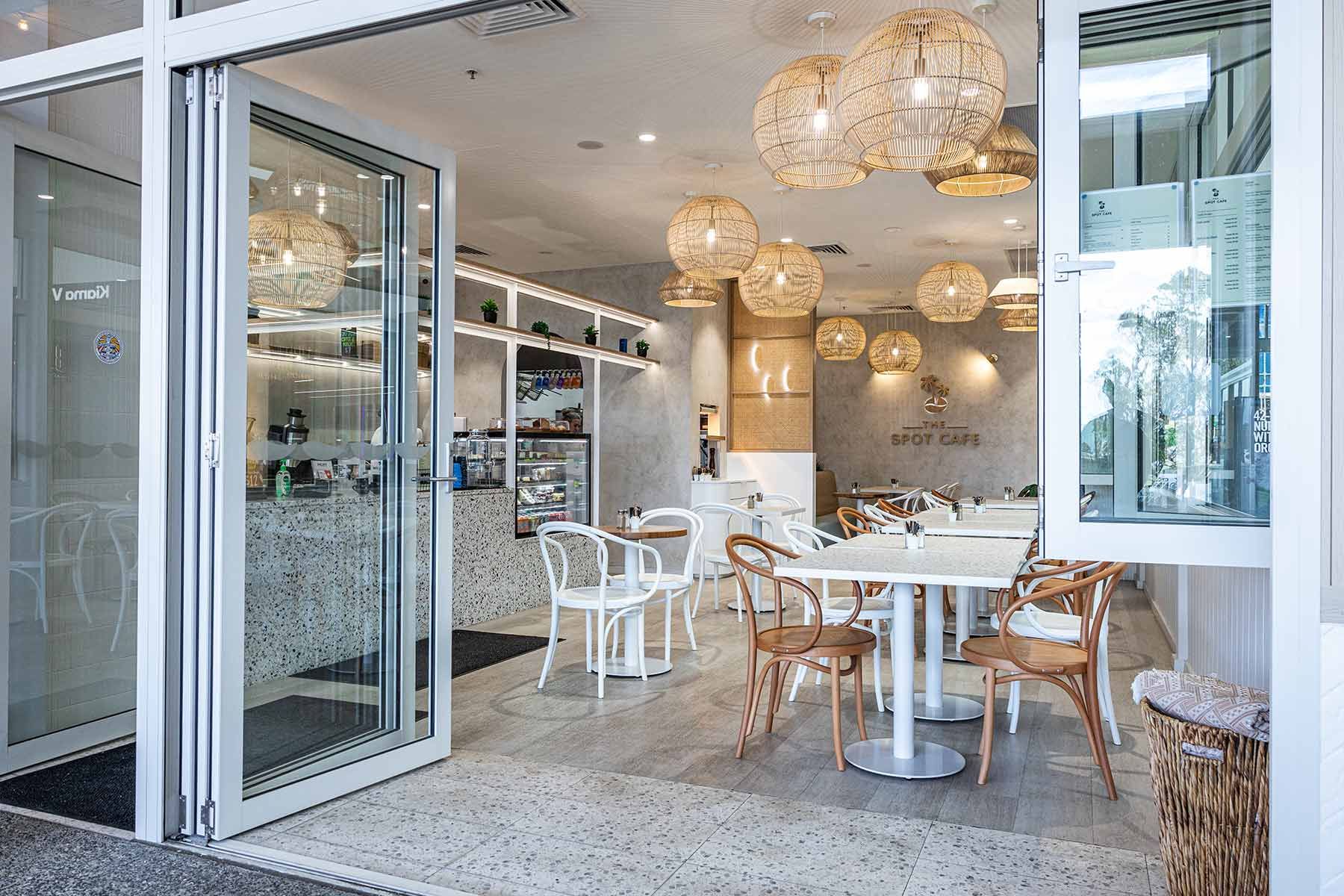 Cafe Interior With an Open Glass Door — JMB Electrical Services In Port Kembla, NSW