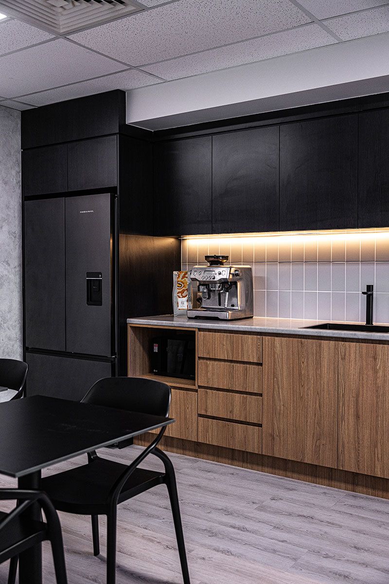 Kitchen With Black and Wood Cabinetry — JMB Electrical Services In Port Kembla, NSW