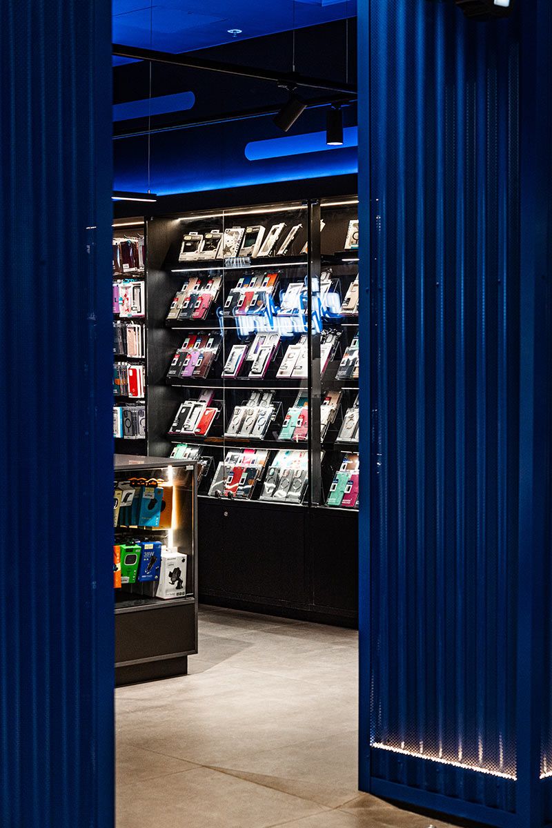 Sleek Shelves Filled With Colourful Phone Cases — JMB Electrical Services In Port Kembla, NSW