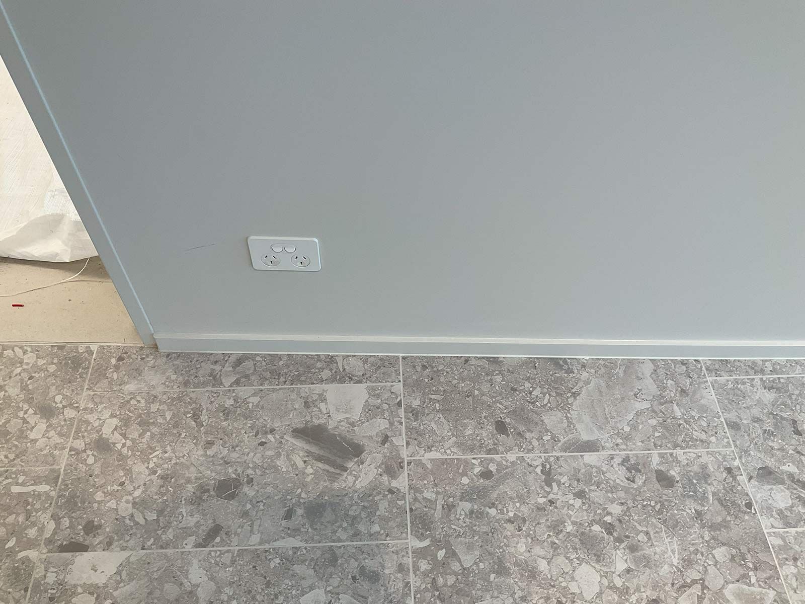 A Light Gray Wall With a Double Power Outlet — JMB Electrical Services In Port Kembla, NSW