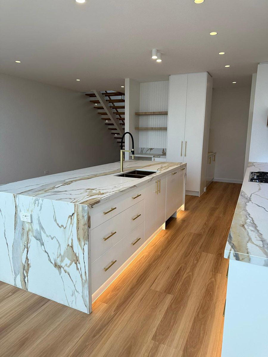 Kitchen With a Marble Island and Under-cabinet Lighting — JMB Electrical Services In Port Kembla, NSW