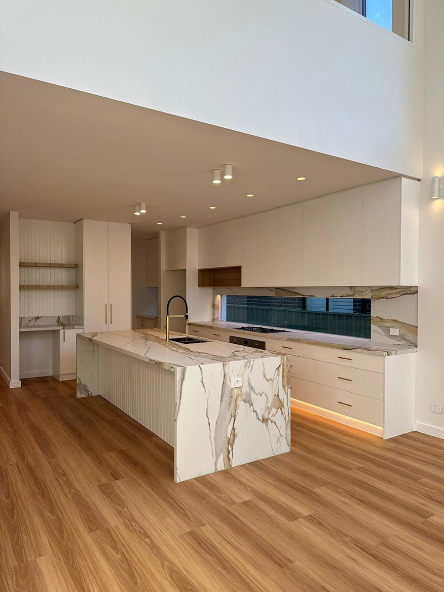 Kitchen With a Marble Island and Backsplash — JMB Electrical Services In Port Kembla, NSW