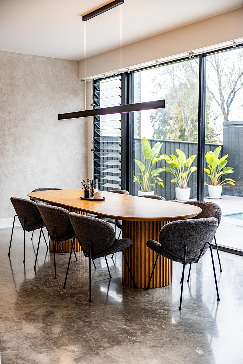 Dining Room With a Long Wooden Table Surrounded by Six Grey Chairs — JMB Electrical Services In Port Kembla, NSW