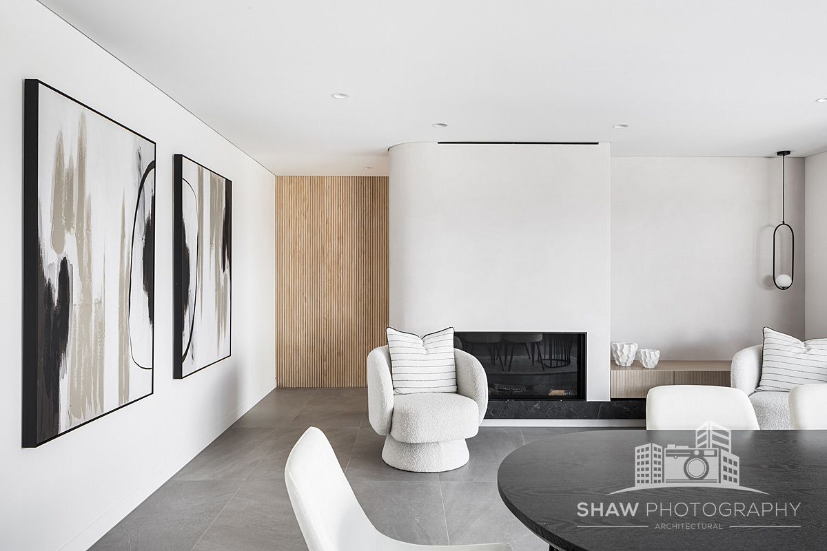 A Living Room With a Fireplace and Paintings on the Wall — JMB Electrical Services In Port Kembla, NSW