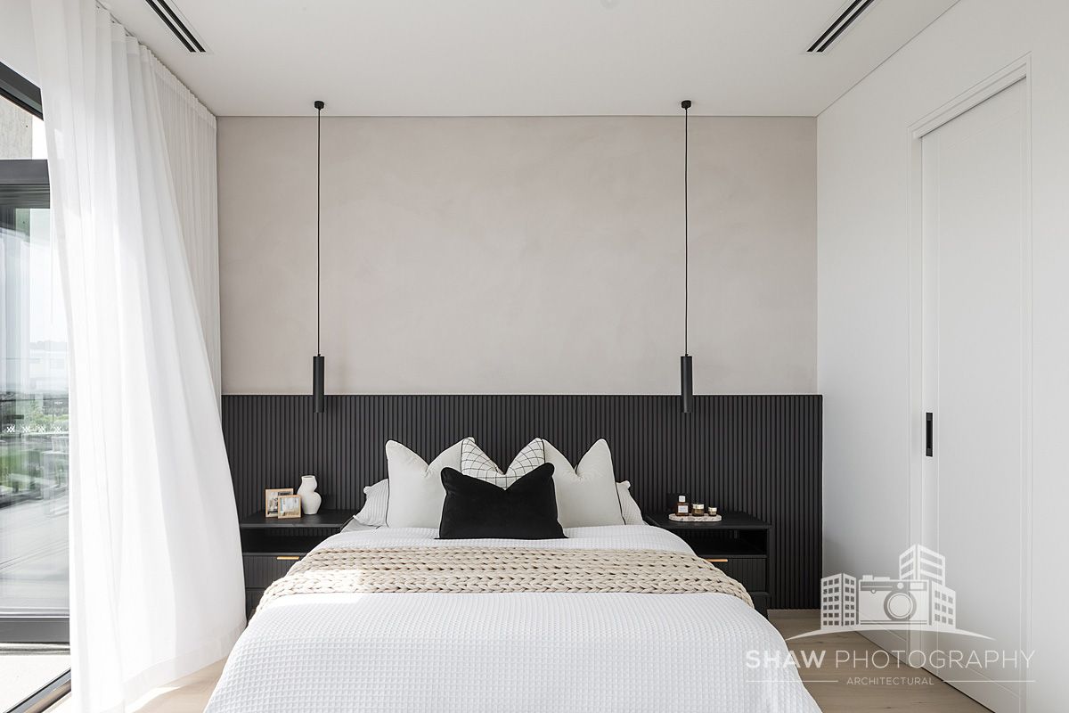 A Bedroom With a Large Bed and a Black Headboard — JMB Electrical Services In Port Kembla, NSW