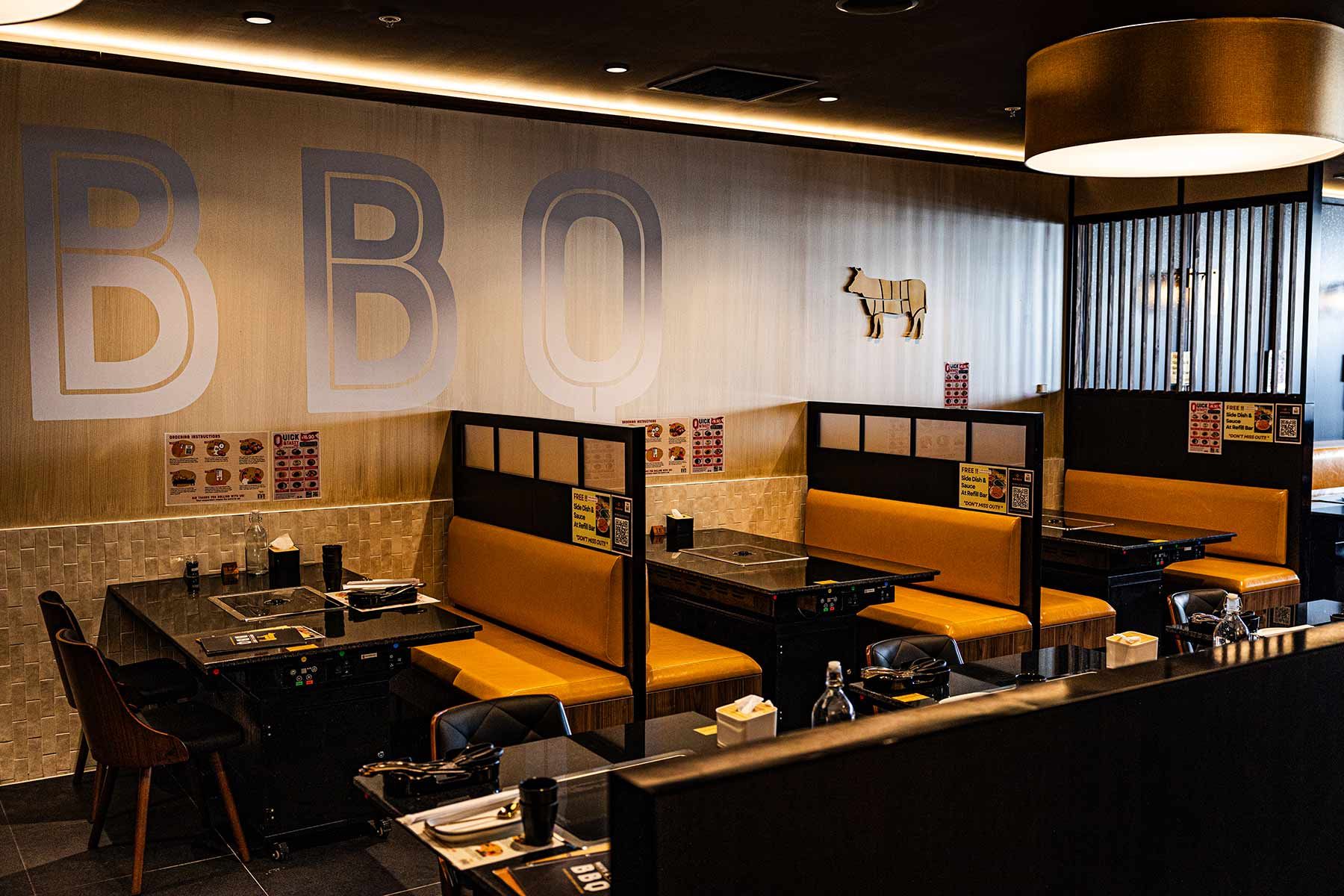 Cozy BBQ Restaurant With Black Tables and Integrated Grills — JMB Electrical Services In Port Kembla, NSW