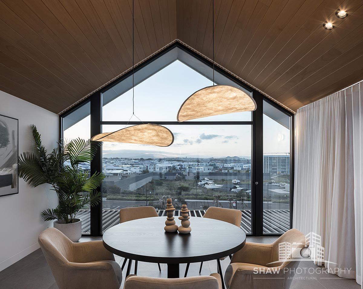 A Round Table and Chairs in Front of a Large Window — JMB Electrical Services In Port Kembla, NSW