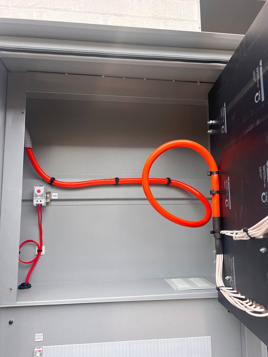 An Orange Cable and Red Wires Are Neatly Arranged — JMB Electrical Services In Port Kembla, NSW