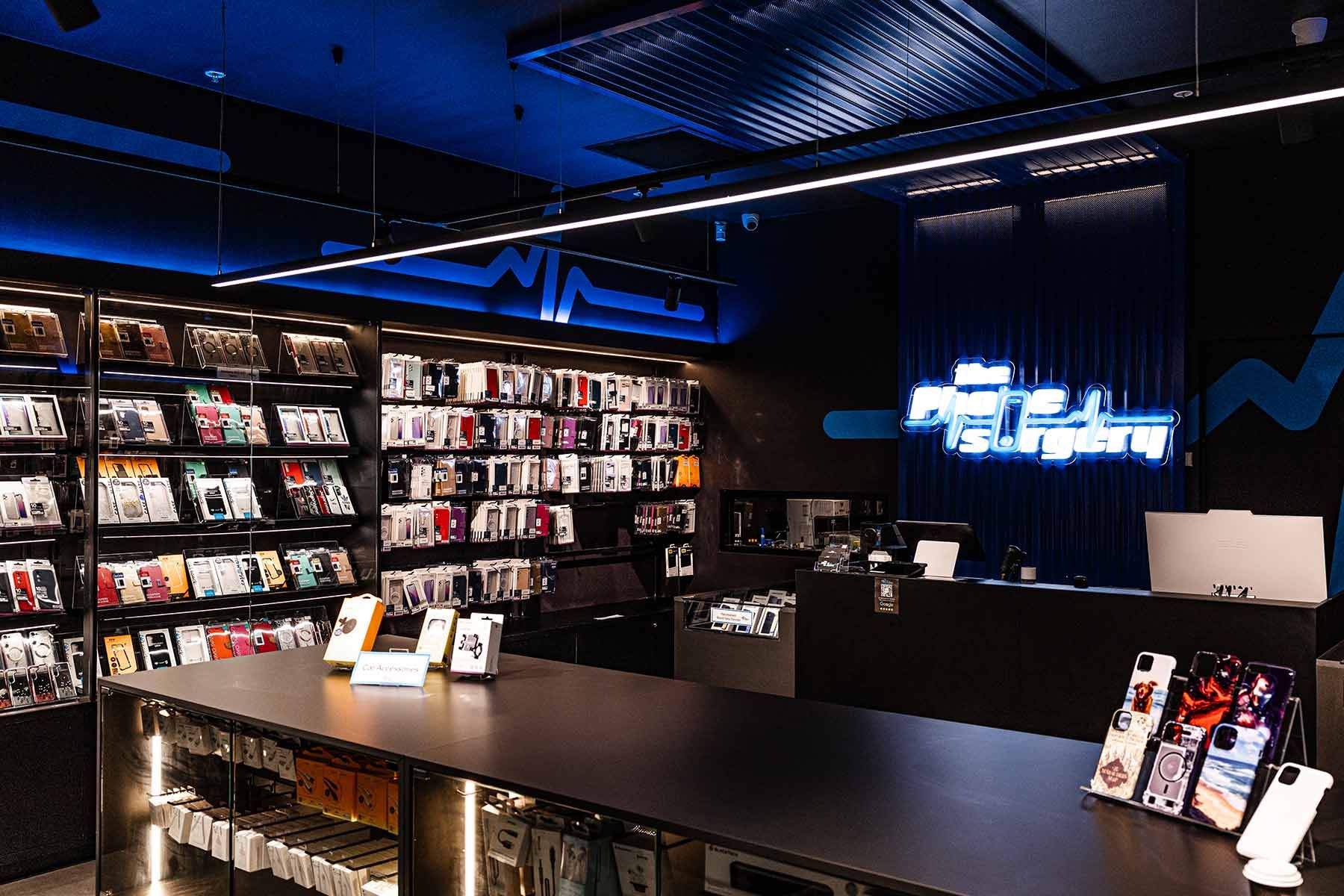 Vibrant Backlit Shelves Displaying Colourful Phone Cases — JMB Electrical Services In Port Kembla, NSW