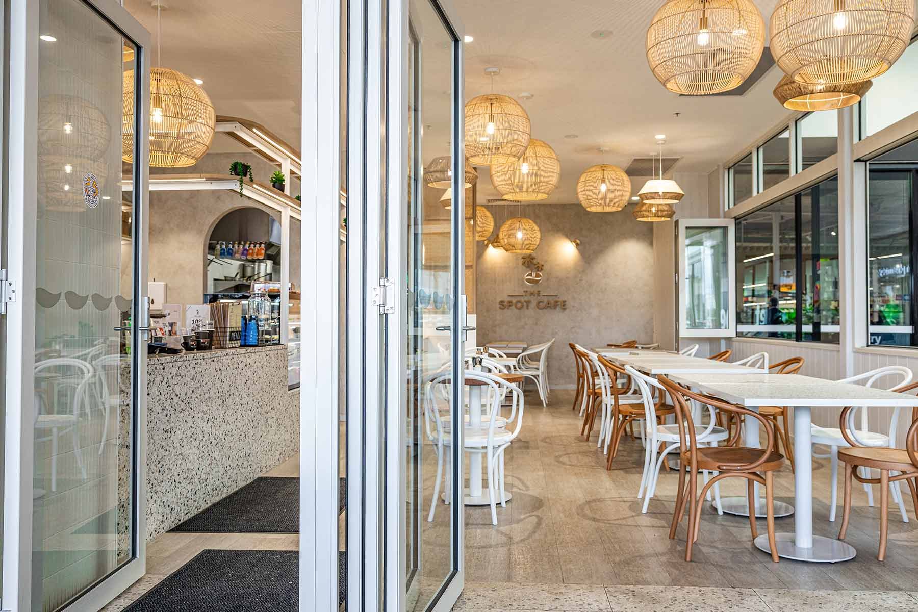 Cafe Interior With White Tables and Wooden Chairs — JMB Electrical Services In Port Kembla, NSW