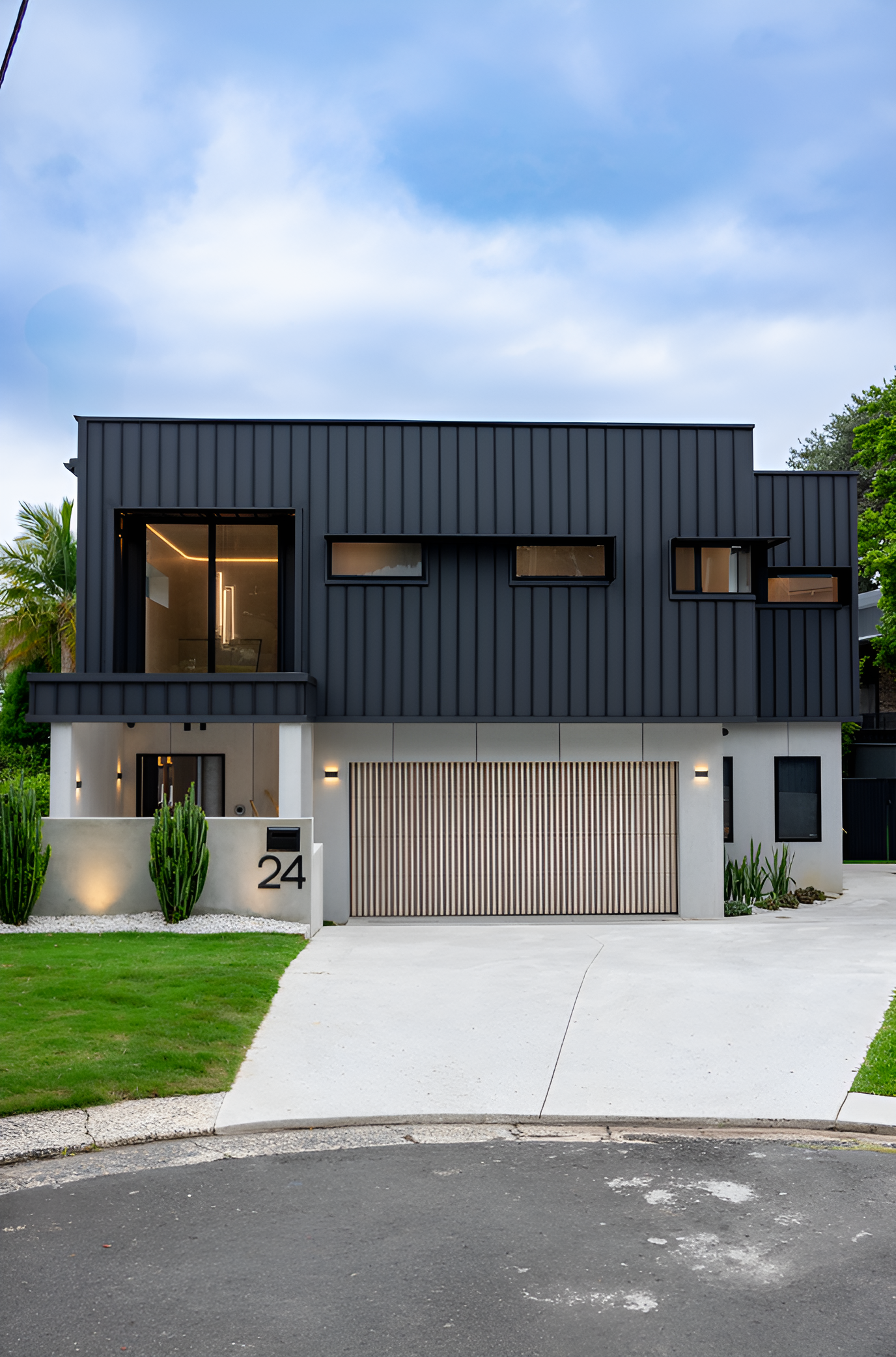 Two-storey House With Black Cladding on the Upper Floor — JMB Electrical Services In Port Kembla, NSW