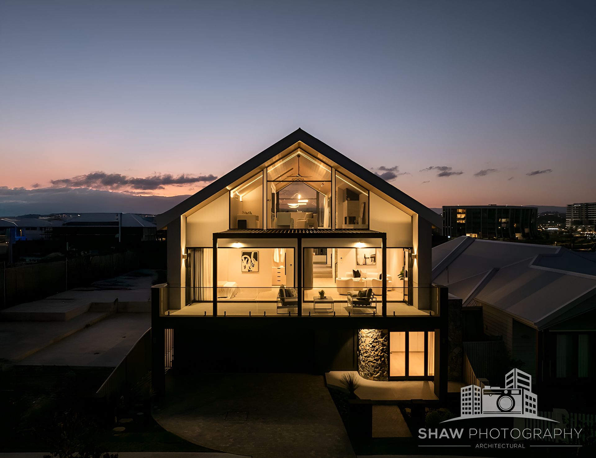 Modern House at Dusk With Warm Interior Lighting — JMB Electrical Services In Port Kembla, NSW