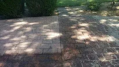 A before and after picture of a brick walkway.