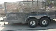 A trailer is parked on the side of the road.