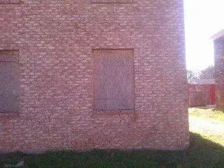 A brick building with a lot of windows on it.