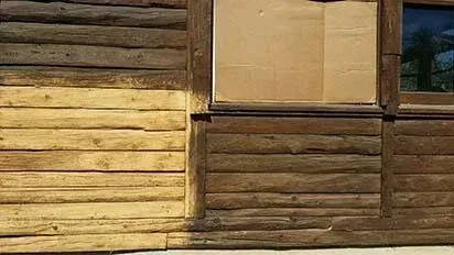 A picture of a log cabin before and after being painted.