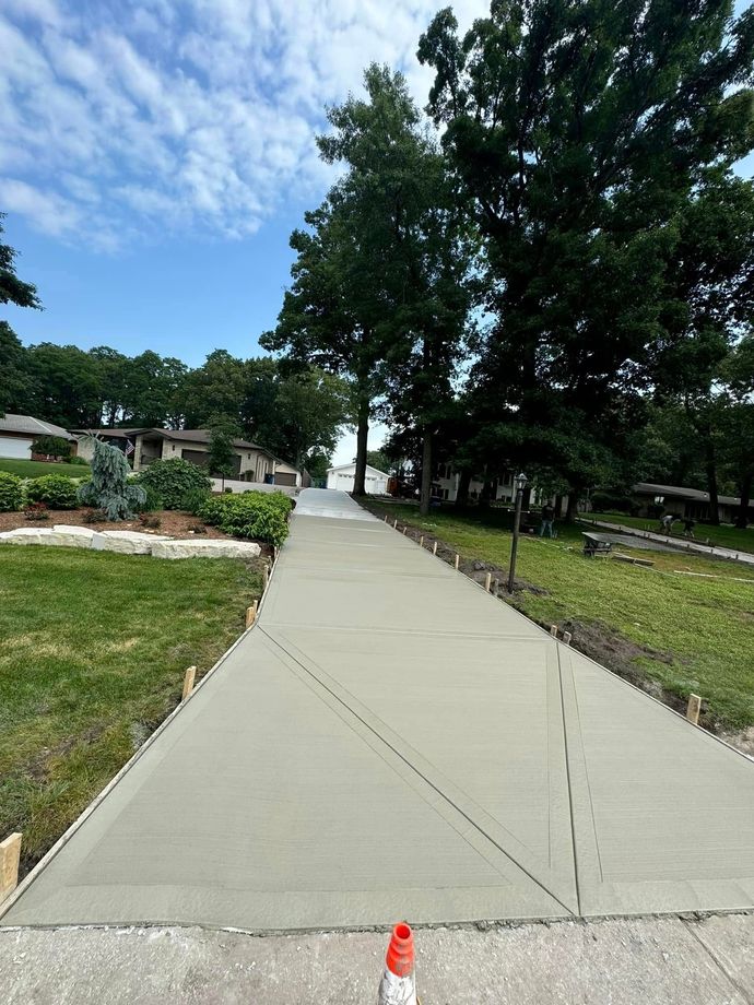 A concrete driveway is being built in a residential area.