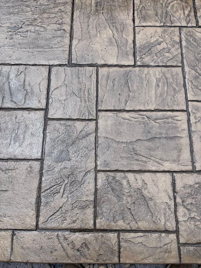 A close up of a brick floor with a brick pattern.