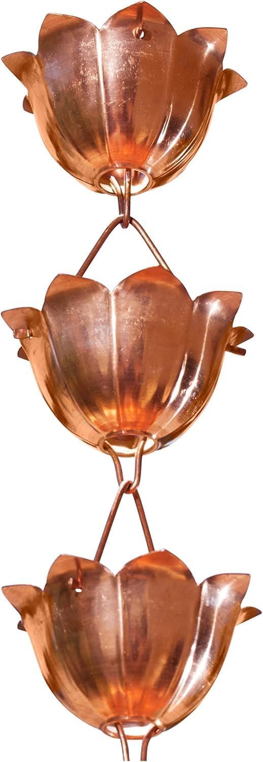 Three copper-colored decorative flower-shaped ornaments stacked vertically on a white background