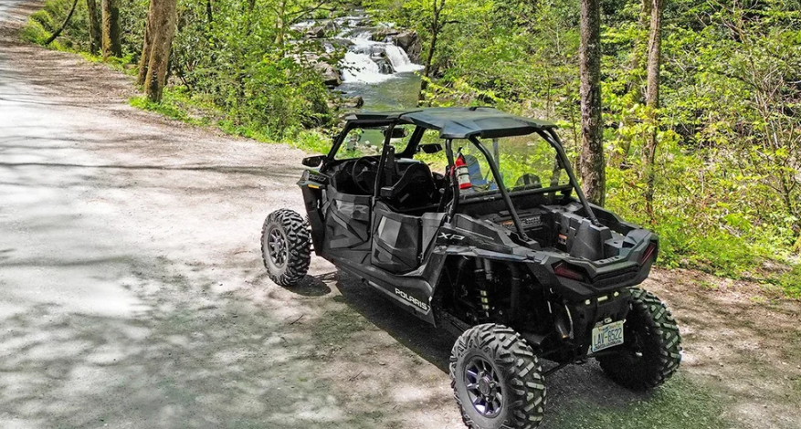 UTV parked near a waterfall