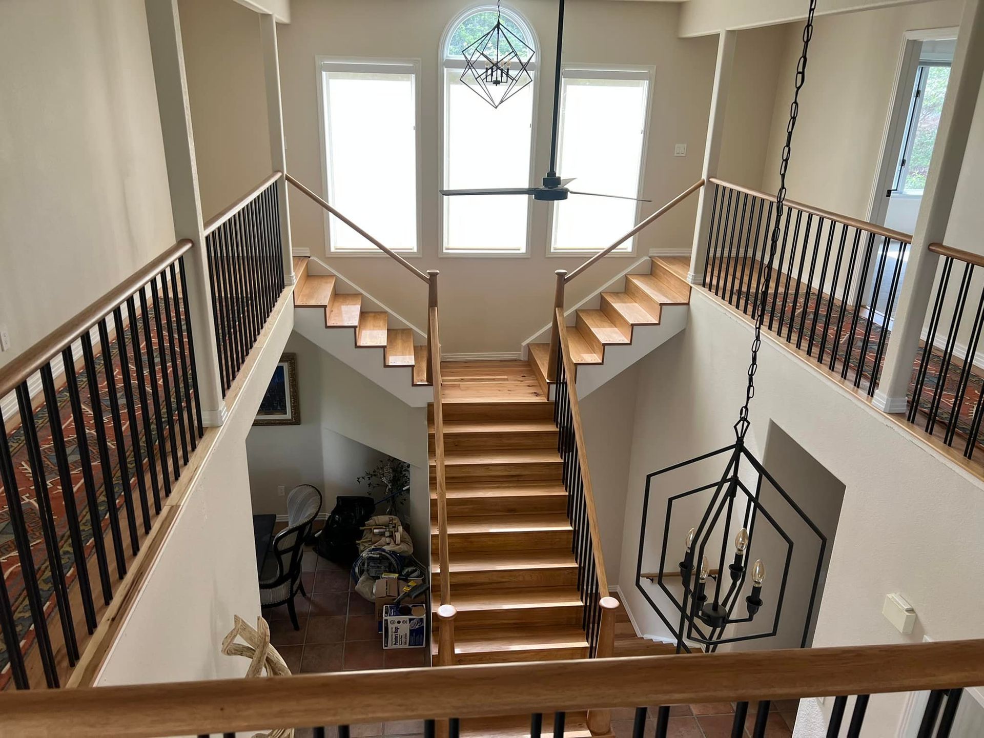 A view of a staircase from the second floor of a house.